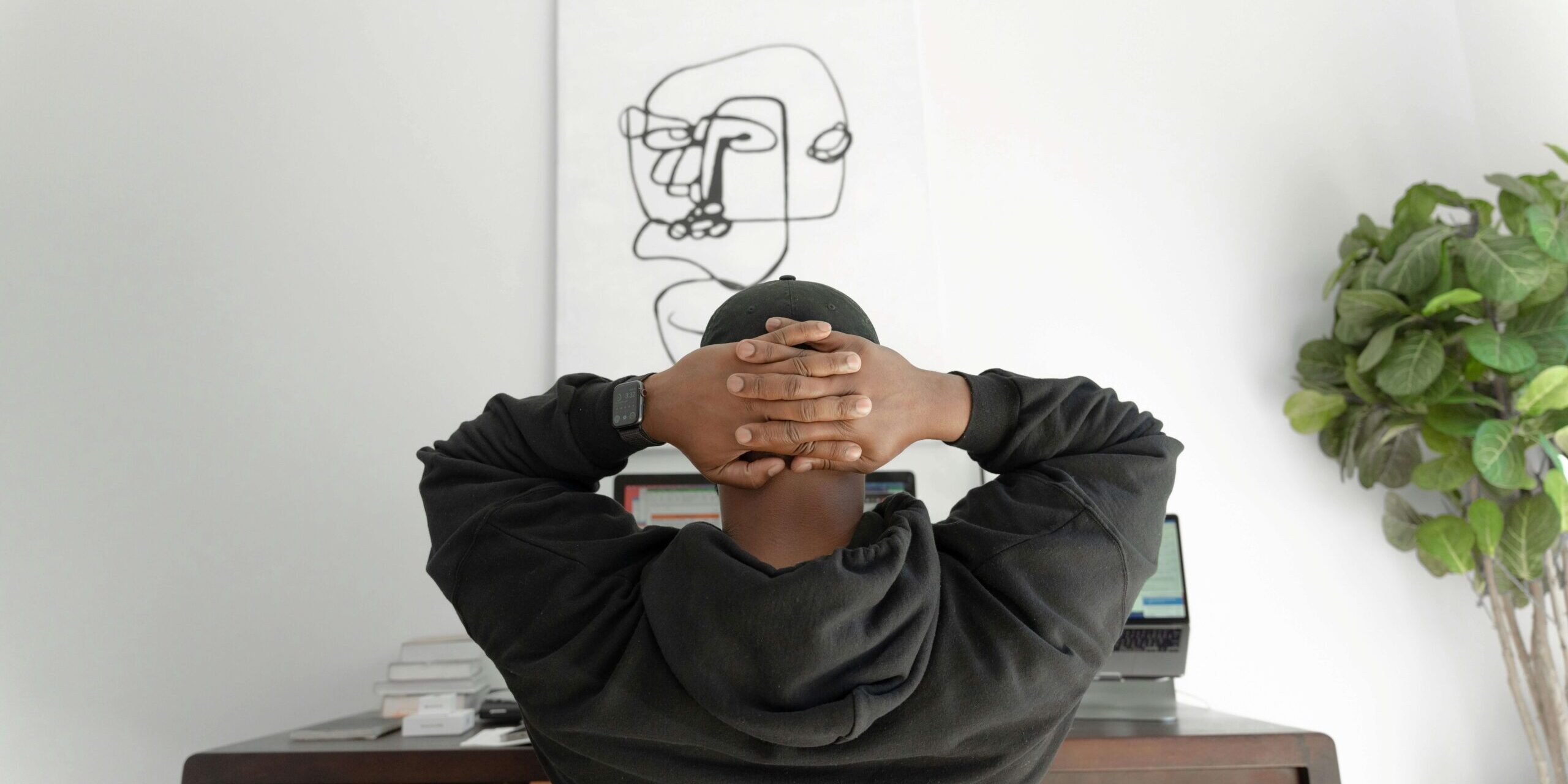 Person looking thoughtful at desk with paper, ADHD vs anxiety differential diagnosis Denver CO
